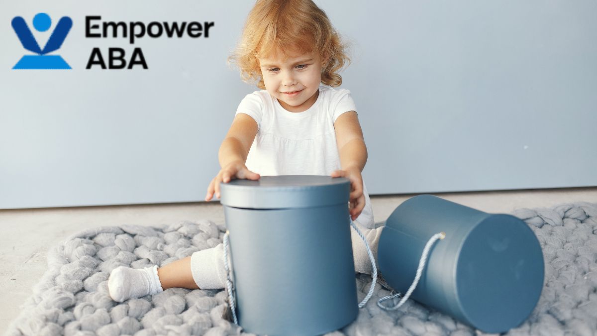 Play schemas autism, a young child experiments with containers during imaginative play exploration.