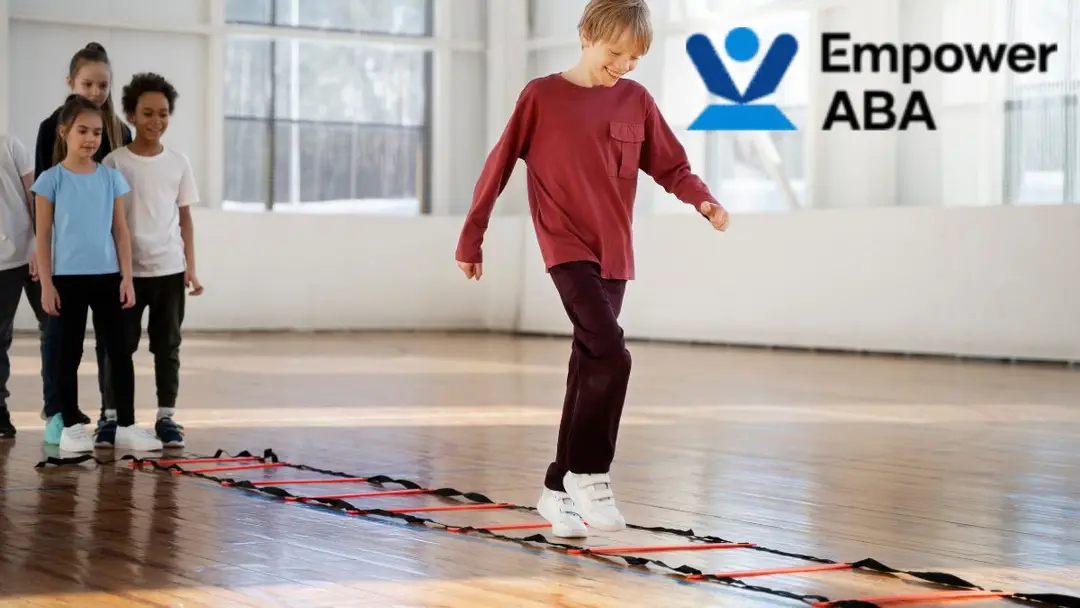 Sensory integration therapy autism: A young boy navigates a simple indoor obstacle course as his peers look on, building balance and confidence through play.