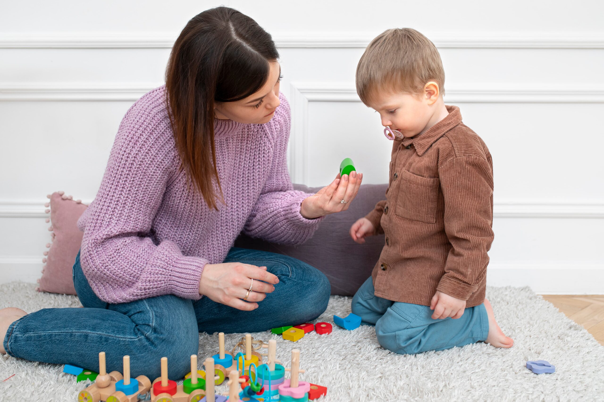 full shot mother kid playing together 1 scaled