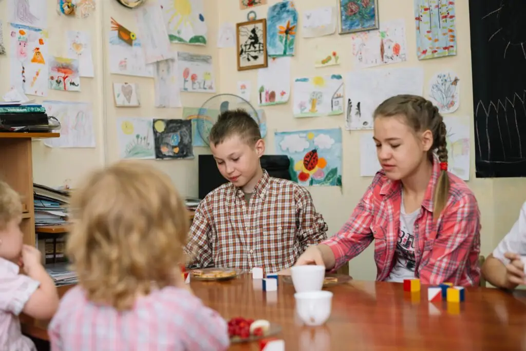children sitting table classroom 2