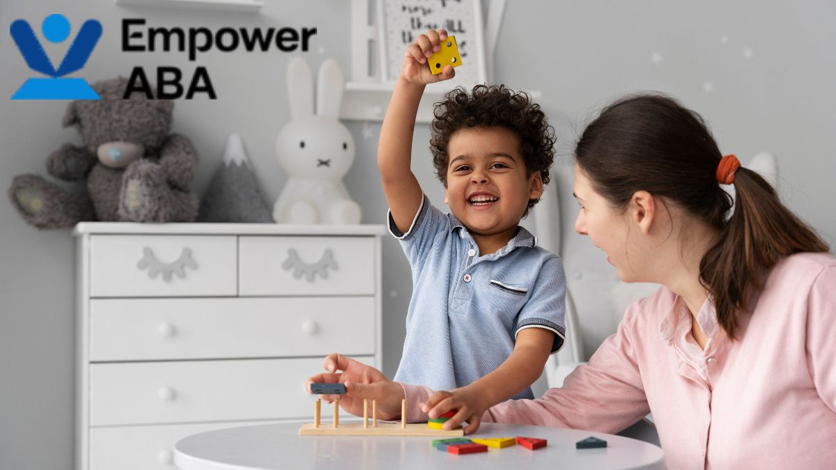 A young boy is guided by a therapist during a joyful autism calming sensory bubble tube therapy session.